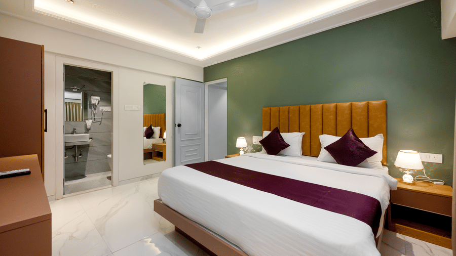 Modern bedroom with king bed and workspace at Home2 Residency, Mumbai Airport