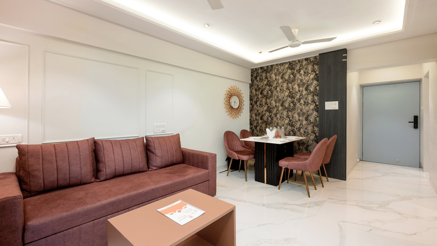 Contemporary living room with sofa and dining area at Home2 Residency, Mumbai Airport