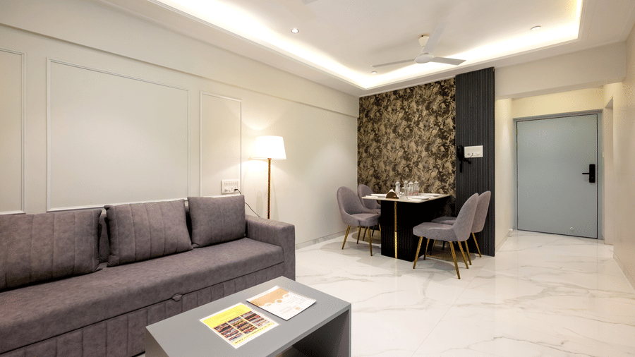 Modern living room with sofa and work desk at Home2 Residency, Mumbai Airport