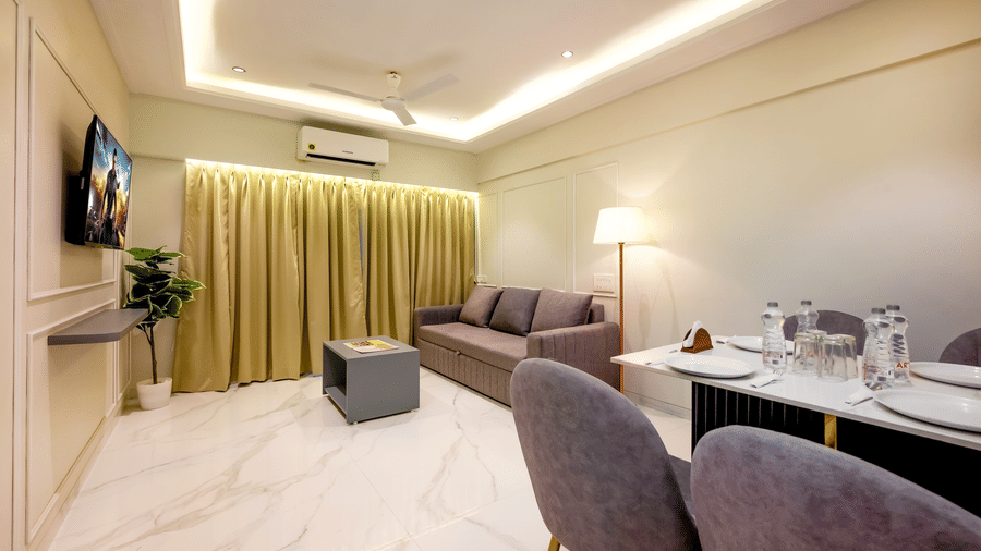Open plan living and dining area with workspace at Home2 Residency, Mumbai Airport