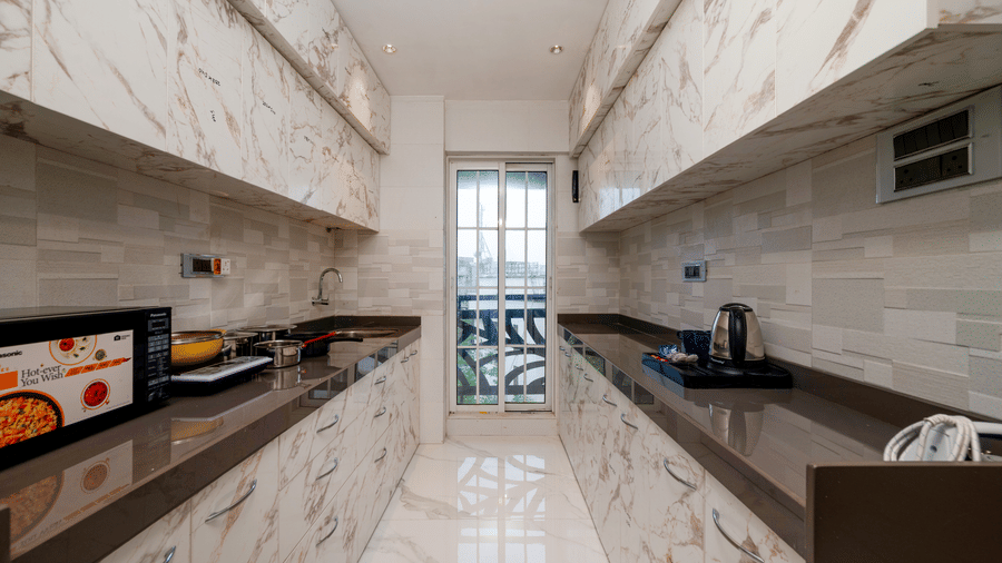 Modern kitchenette with cooking facilities at Home2 Residency, Mumbai Airport