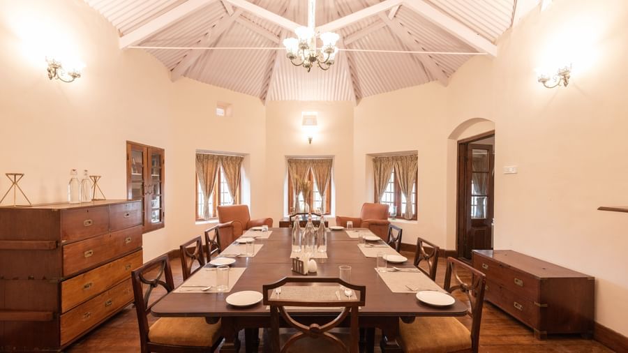 The interiors of the dining hall with a long dining table and rounded walls - Ibex Stays & Trails, Coonoor (Leewood).