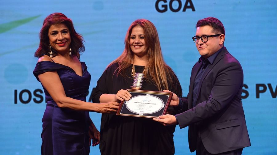 Kiran Bawa receiving an award by a man and a woman - IOSIS Spa & Wellness