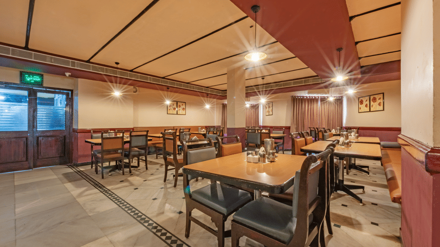 Spacious dining area at Jayaram Hotel, Pondicherry offering comfortable seating in a welcoming restaurant setting.