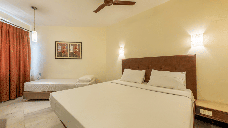 Bright and comfortable double room at Jayaram Hotel, Pondicherry with cosy bedding, modern interiors and natural light.