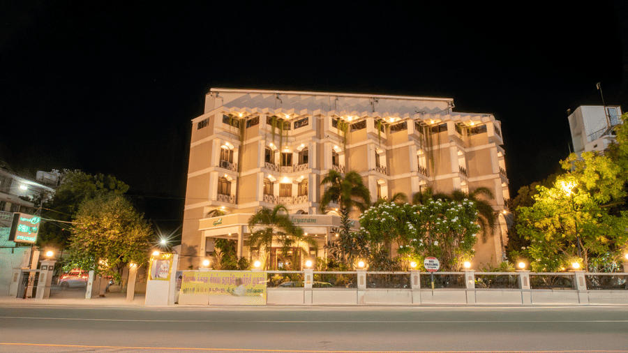 Night view of Jayaram Hotel, Pondicherry showcasing the illuminated hotel façade and inviting entrance.