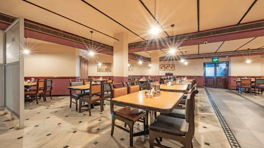 Multi cuisine restaurant at Jayaram Hotel, Pondicherry offering spacious seating and a welcoming dining ambience.