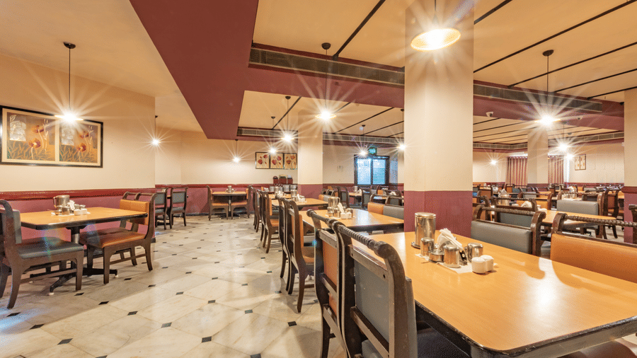 Spacious restaurant interior at Jayaram Hotel, Pondicherry designed for comfortable dining with ample seating.