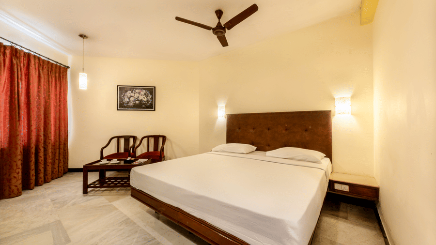 Comfortable Standard Room at Jayaram Hotel, Pondicherry with a cosy bed, seating area and modern amenities.