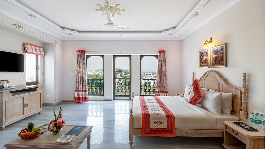 An overview of the suite with a king bed, side tables and coffee table at Maan Vilas Suite - Maan Vilas by Stone Wood, Udaipur
