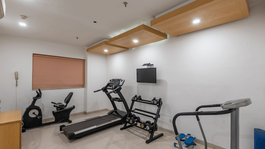 Spacious gym area at Mango Grove with multiple cardio and strength-training equipment.