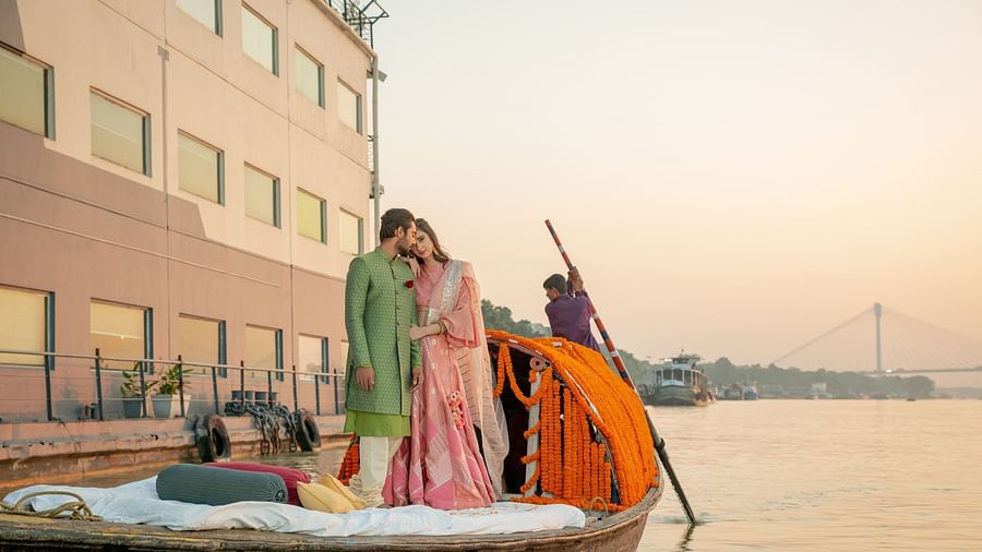 a newly wed standing on a beautifully decorated boat - polo floatel kolkata