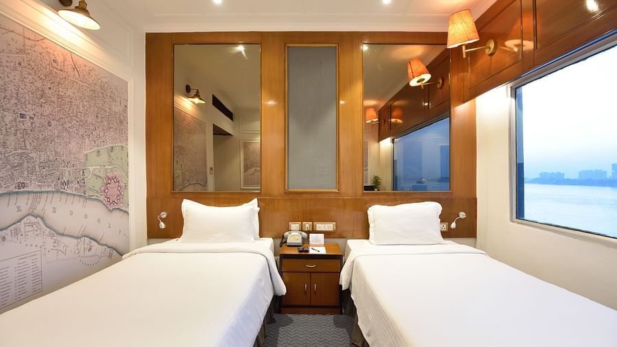 two twin white beds kept side by side - polo floatel kolkata