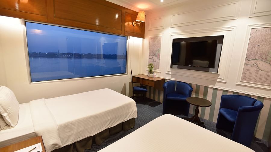 two white beds kept side by side facing the TV 1 - polo floatel kolkata