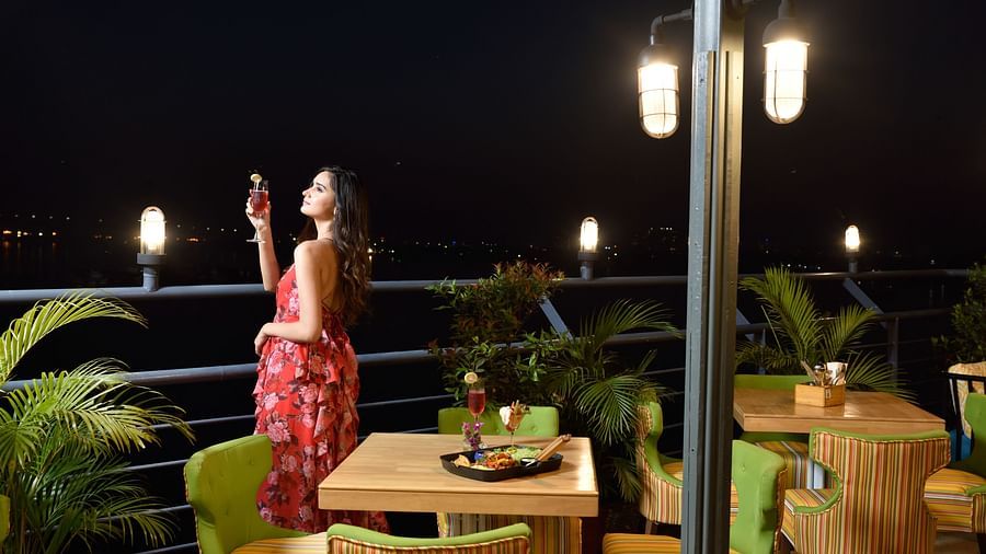 a girl looking at stars from the outside deck  - polo floatel kolkata