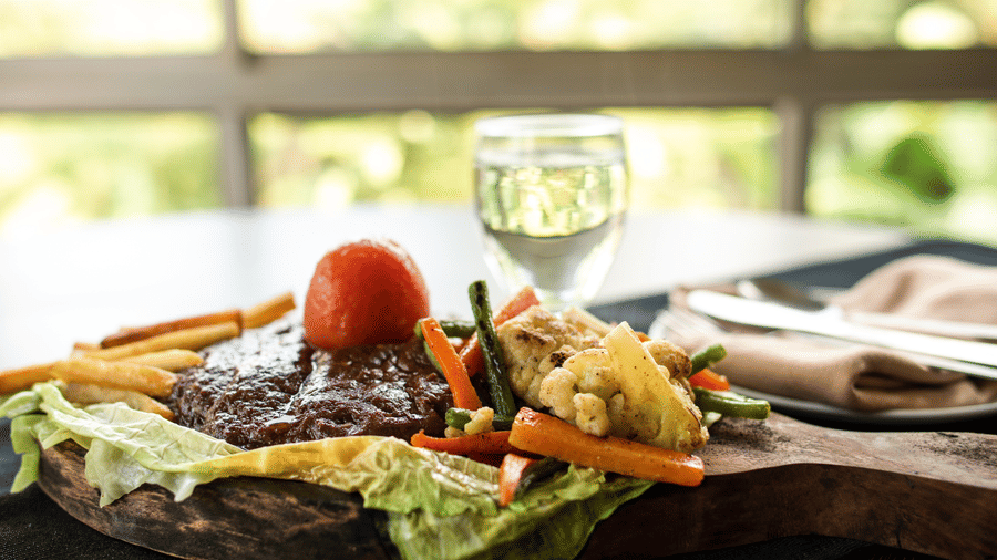 Food at rhe restaurant with a plate containing food, and a glass beside at Polo Hotels, Tura