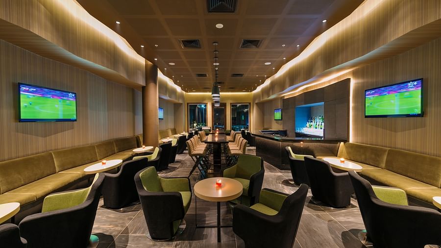 An image of the bar at the Pride Elite Phaltan with its seating arrangement and decorative lighting