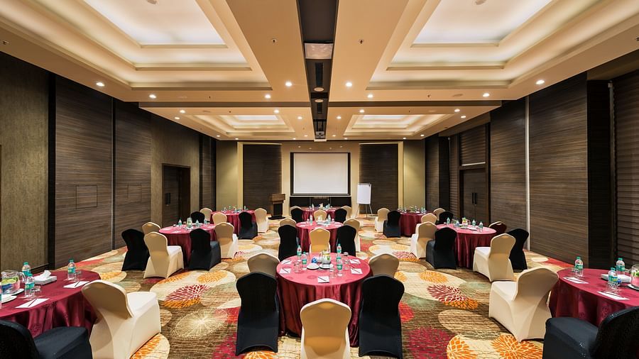 An image of the banquet hall with its seating arrangement, and decorative items - Pride Elite Phaltan