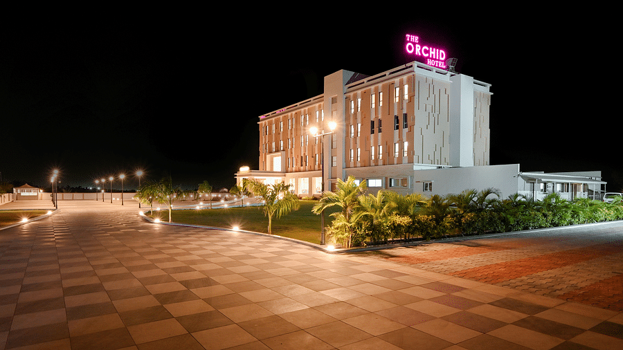 Facade image of The Orchid Hotel, Jamnagar in the night with the lights on 