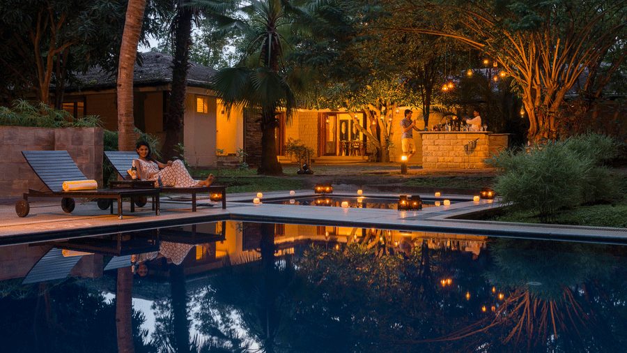 Poolside Restaurant at The Serai Kabini with dim lights and decor.