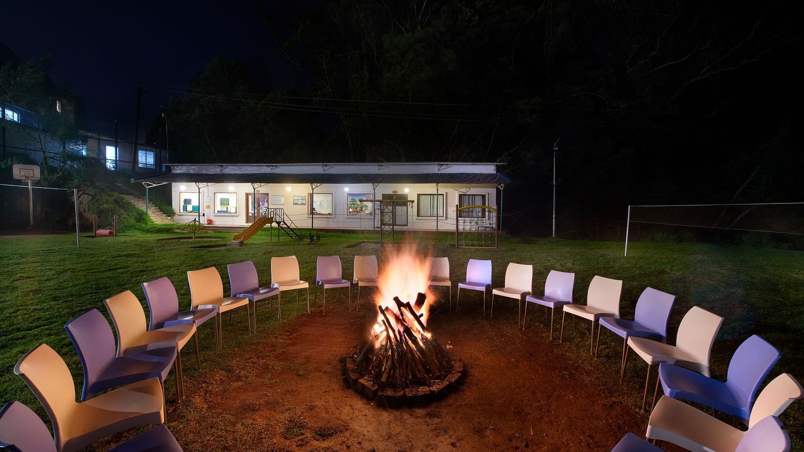 A bonfire arrangement in the lawn at Accord Highland Ooty at night