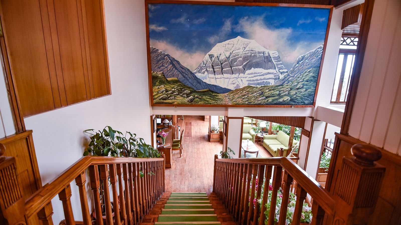 Staircase with mountain mural inside Cedar Inn