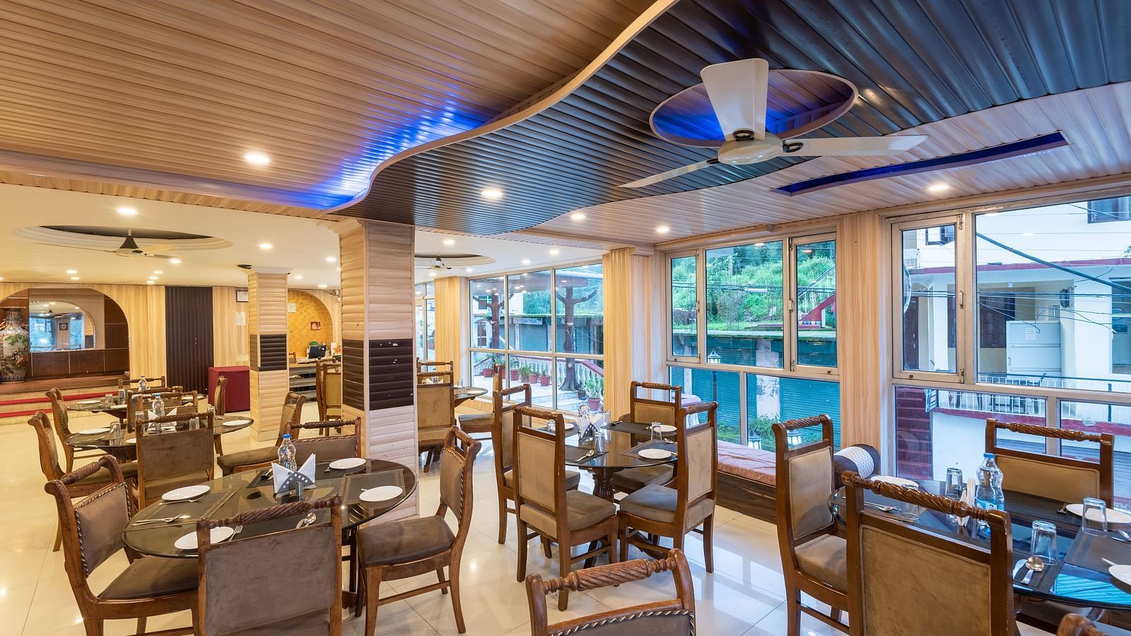 Image of the dining area featuring table and chairs | DLS Anupam Resort, Dharamshala