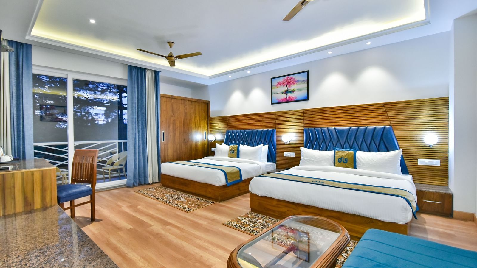 Two large beds with elegant interiors and ambient lighting in Family Suite Room at DLS Ark Holiday Inn, Banikhet.