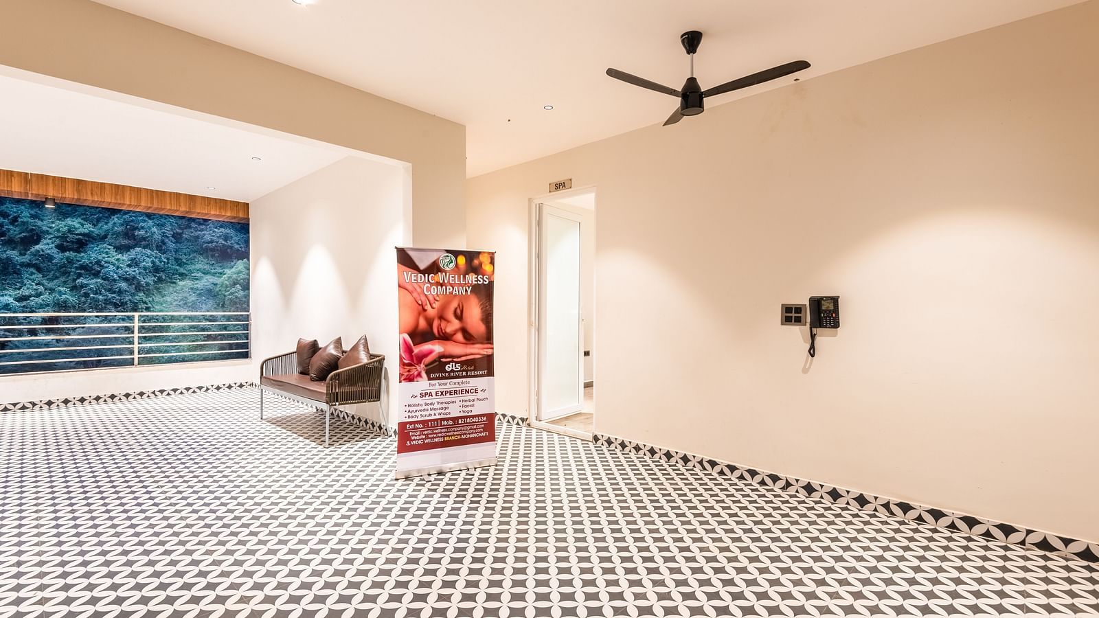 Entrance of Spa at DLS Divine River Resort and Spa with black and white floors and a banner.