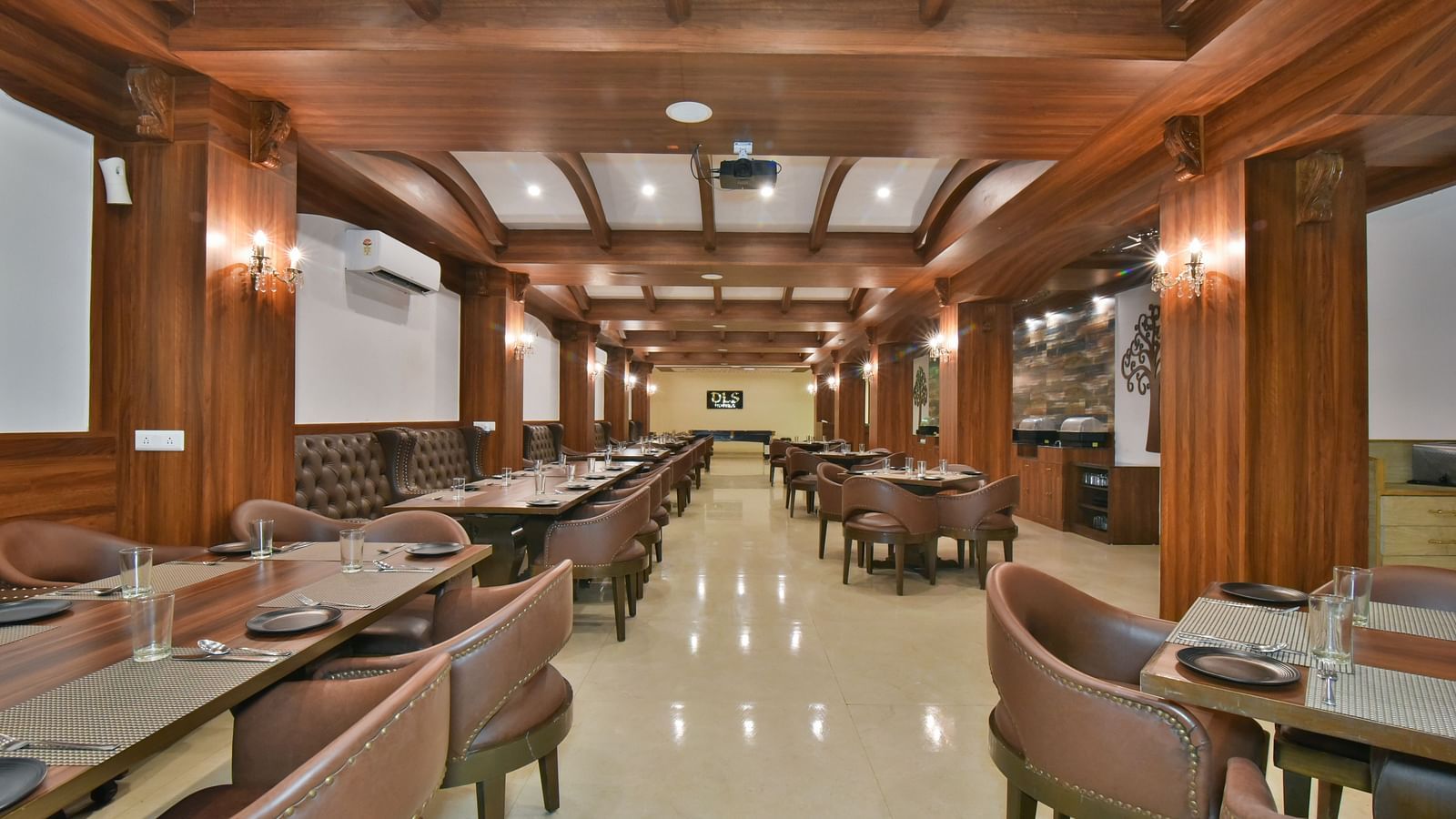 Dining seating with comfortable chairs around table at Ruttba at DLS Highland Resort and Spa, Mussoorie.