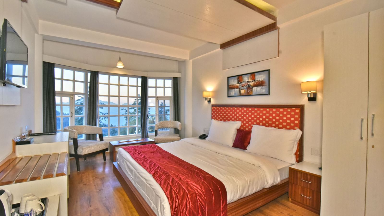 Bedroom with a fancy ceiling and warm illuminating lights at DLS Hillcrest Resort, Shimla.