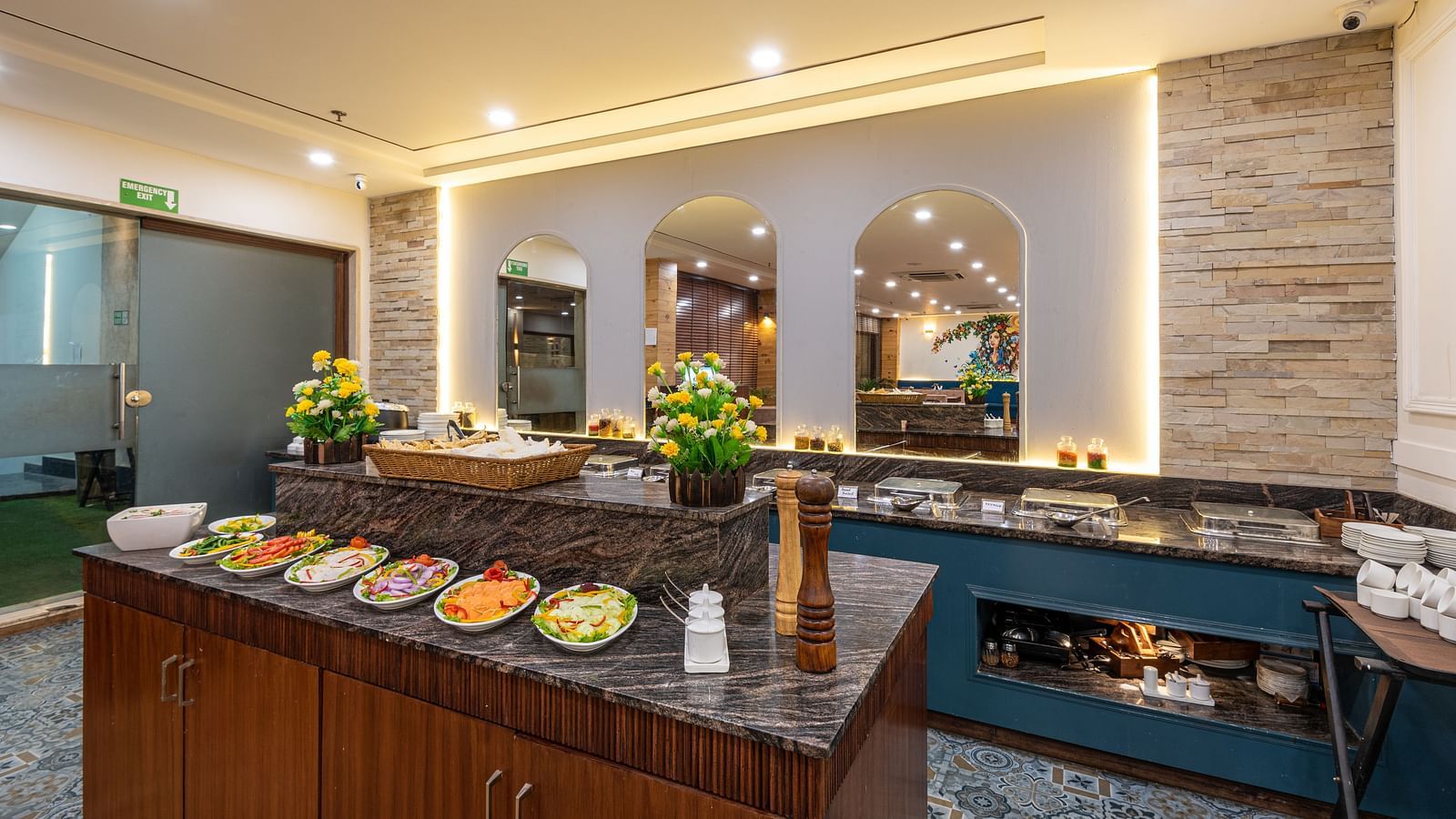 Restaurant with a fresh salad bar and buffet setup in the background at DLS The Classio