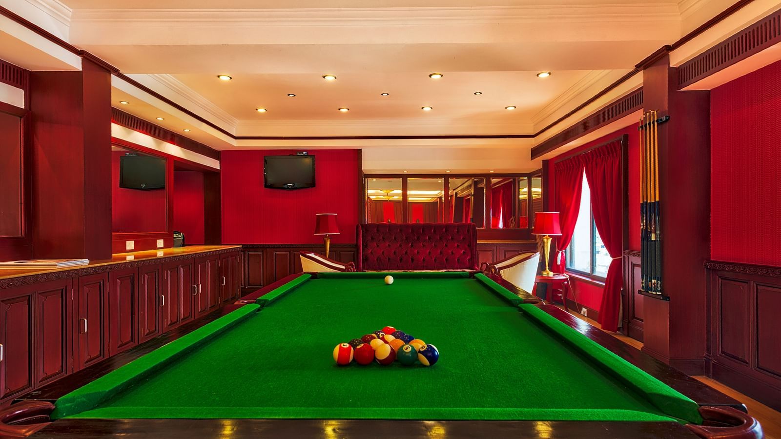 A snooker table  with balls at Grand Chennai By GRT Hotels.