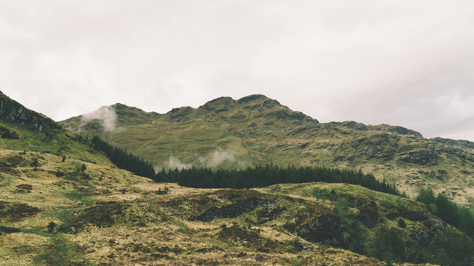 image of a hill with patches of grenery scattered throughout the landscape