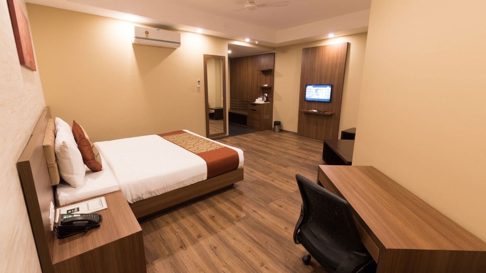 Super Deluxe Rooms with Complimentary Wi-Fi captured with a cosy bed and white linens along with a beige couch - Le ROI Digha Hotel West Bengal4