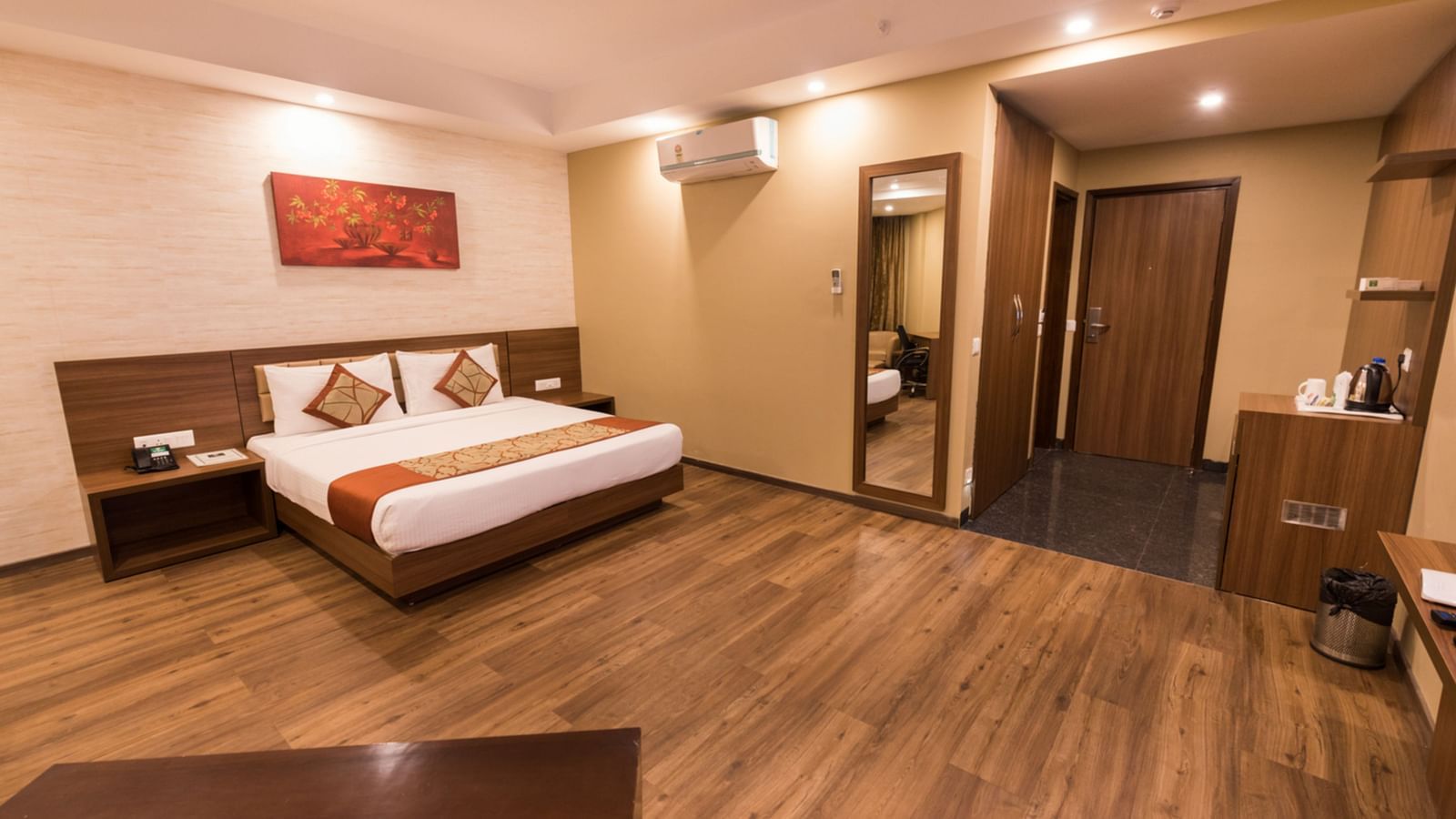 Super Deluxe Rooms with Complimentary Wi-Fi captured with a cosy bed and white linens along with a beige couch - Le ROI Digha Hotel West Bengal6