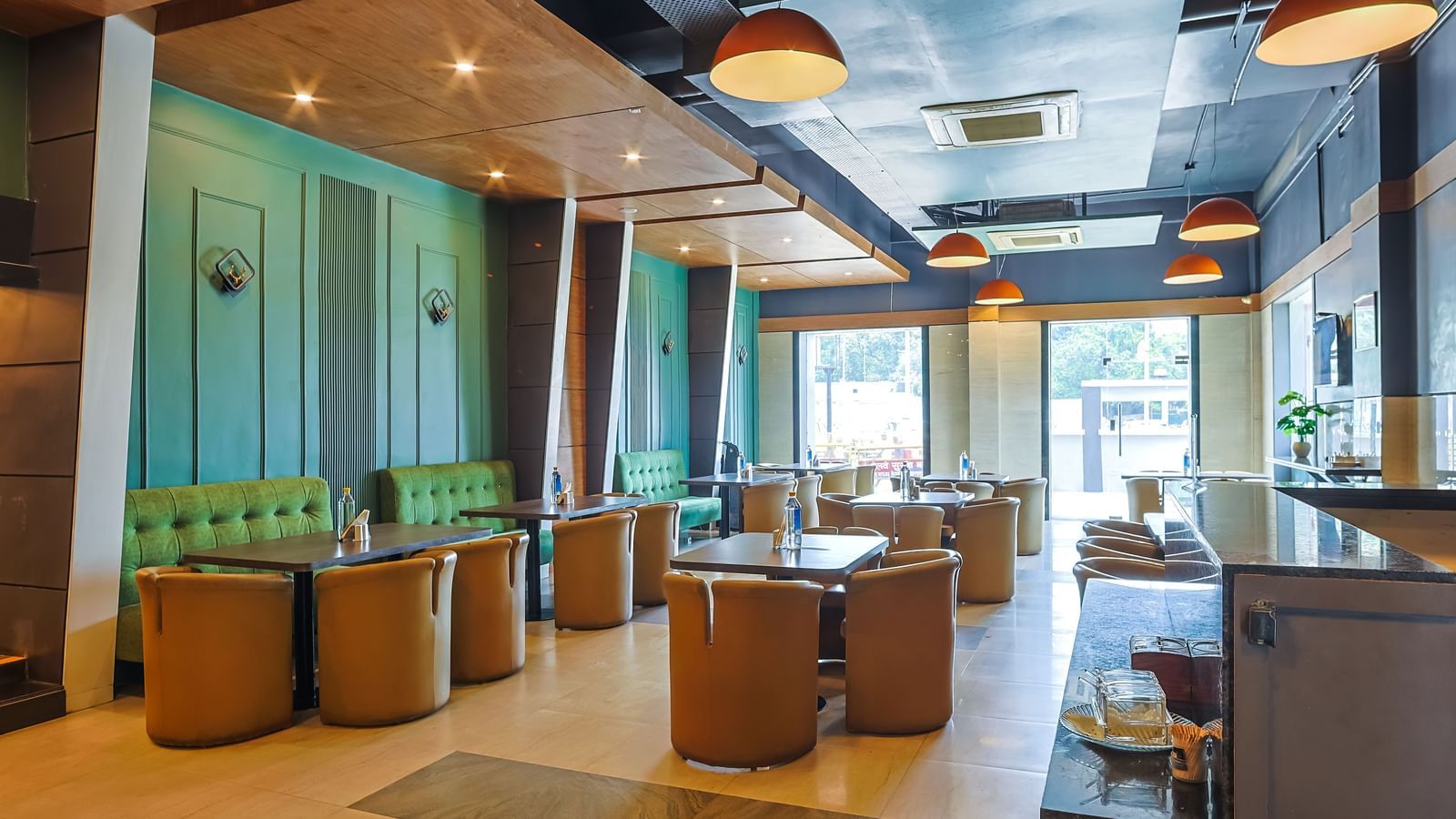 Restaurant dining area with tables, chairs and open layout at Max Hotel Prayagraj.