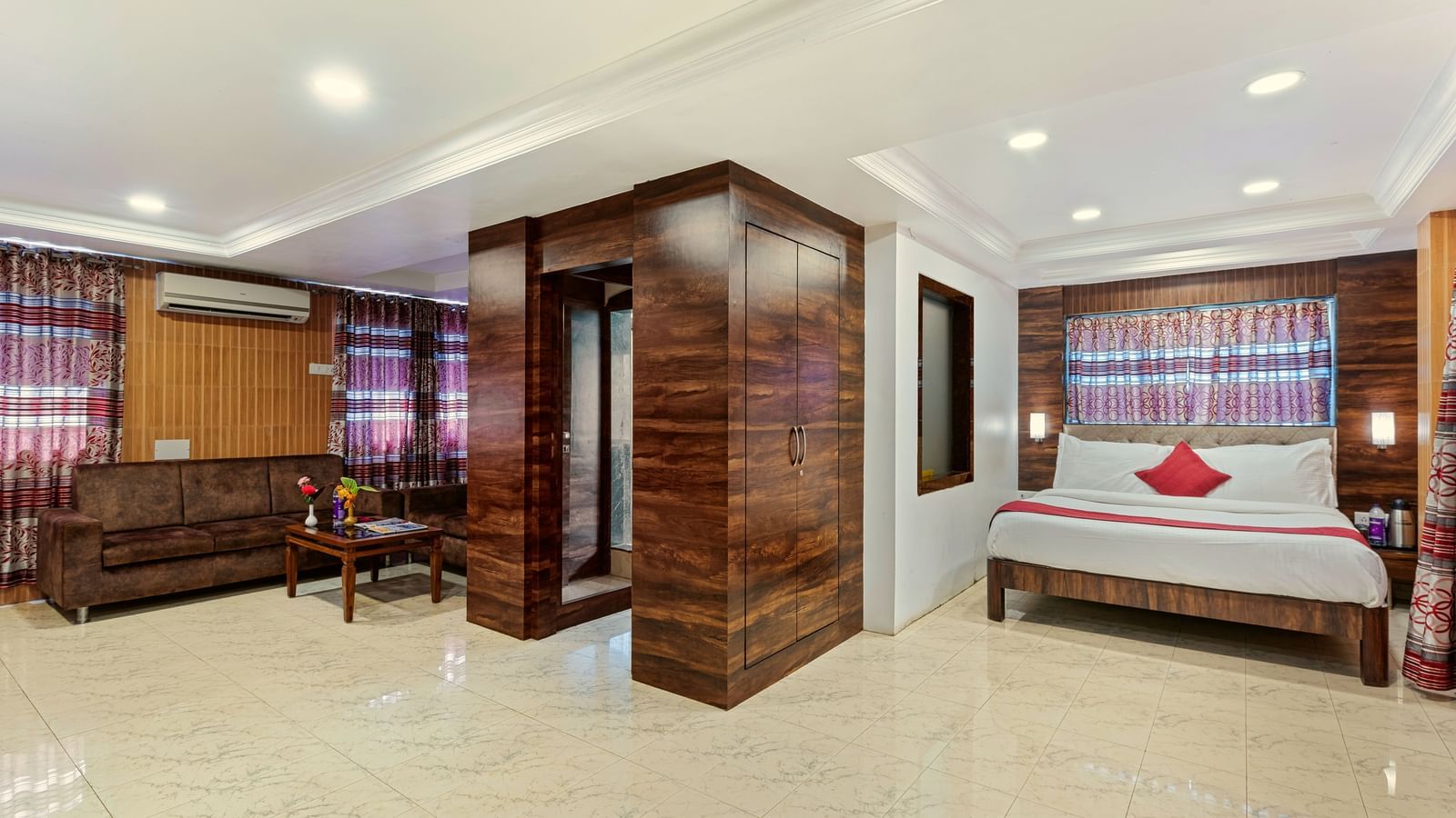 Spacious suite at Mayur Retreat with a seating area, bright lighting, and contemporary decor.