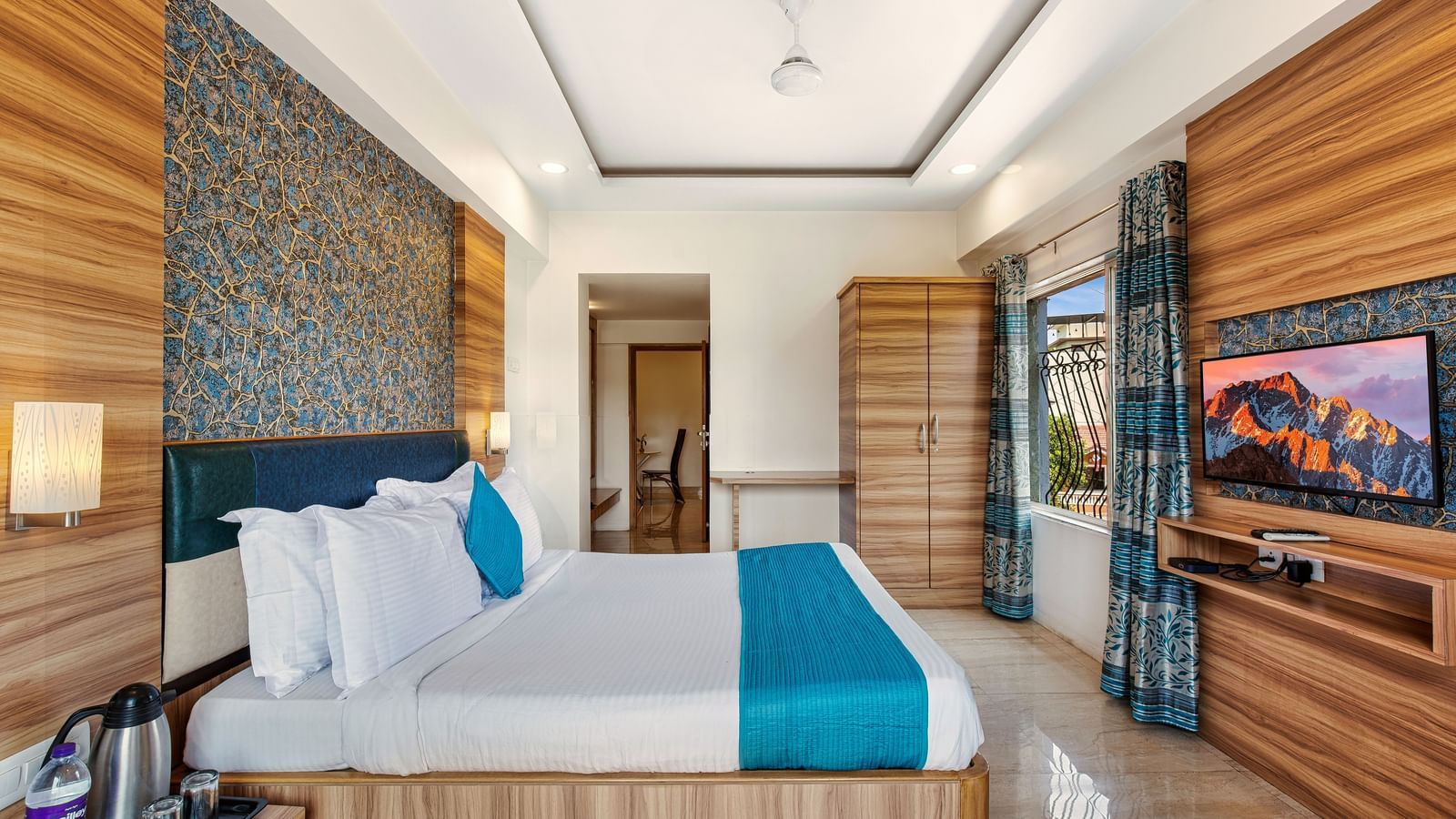 Stylish room at Mayur Retreat with elegant furnishings, blue-themed decor, and a serene ambiance.
