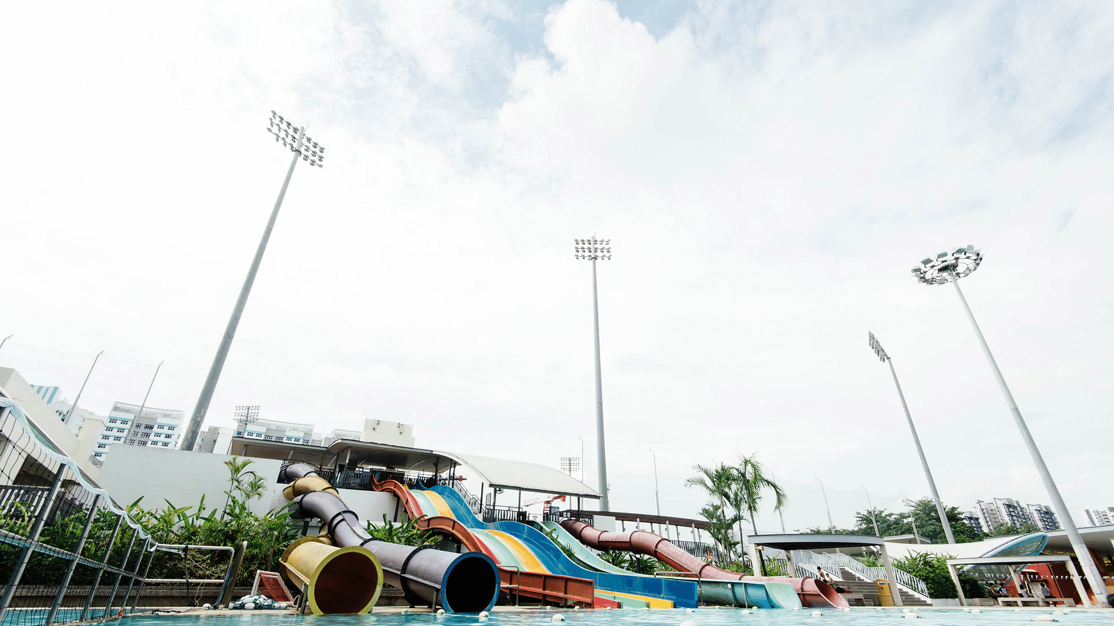an overview of a water park with many rides on it and a waterbody at the end