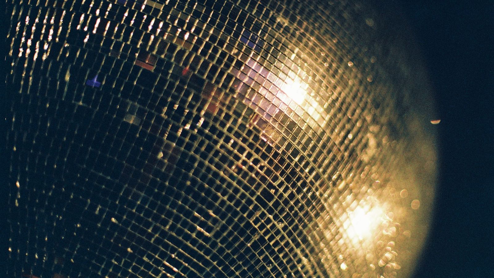 a close up shot of a disco ball with lights shining on it