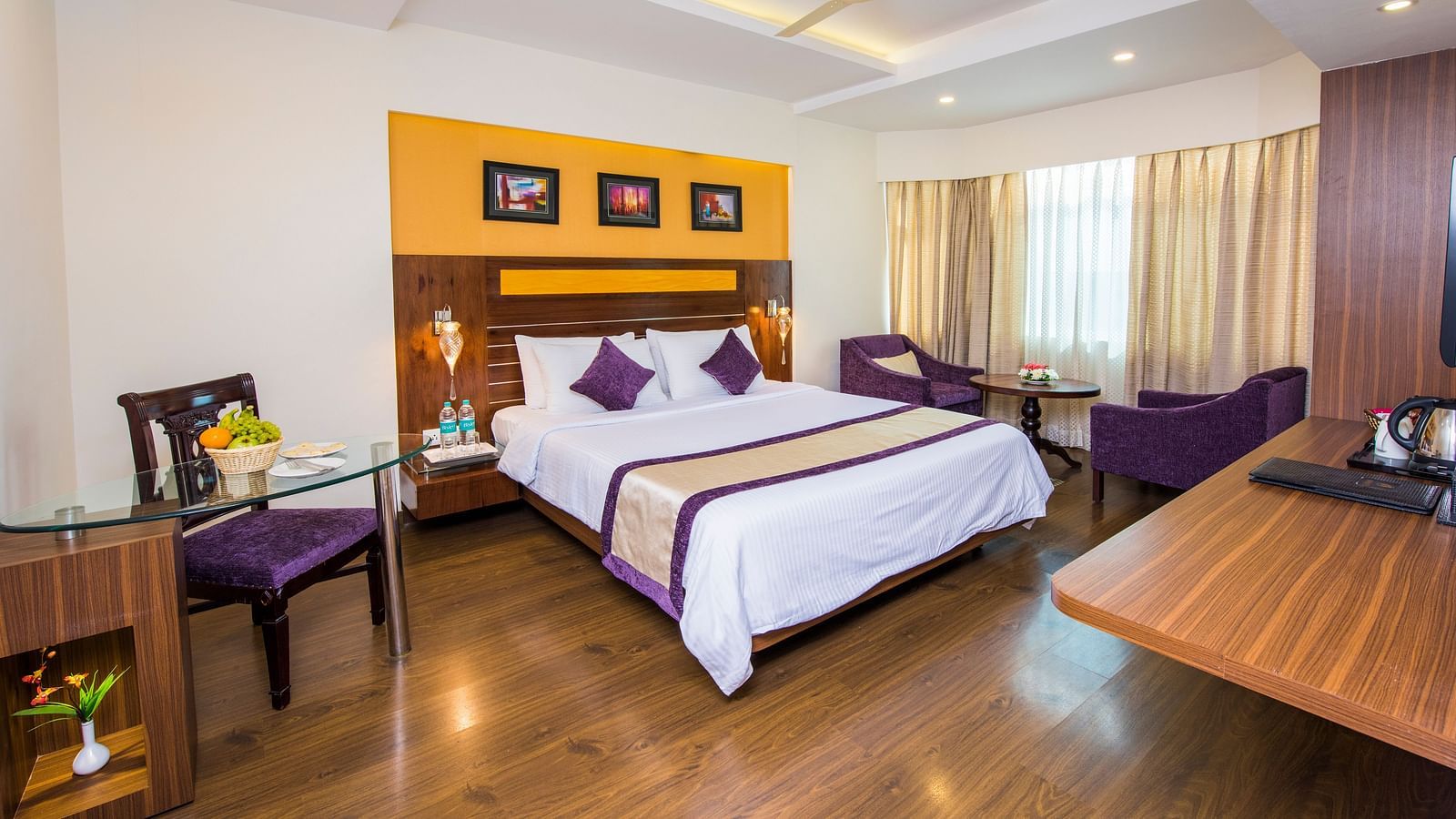 Grand Room with bed, table and seating area at Swosti Grand, Bhubaneswar