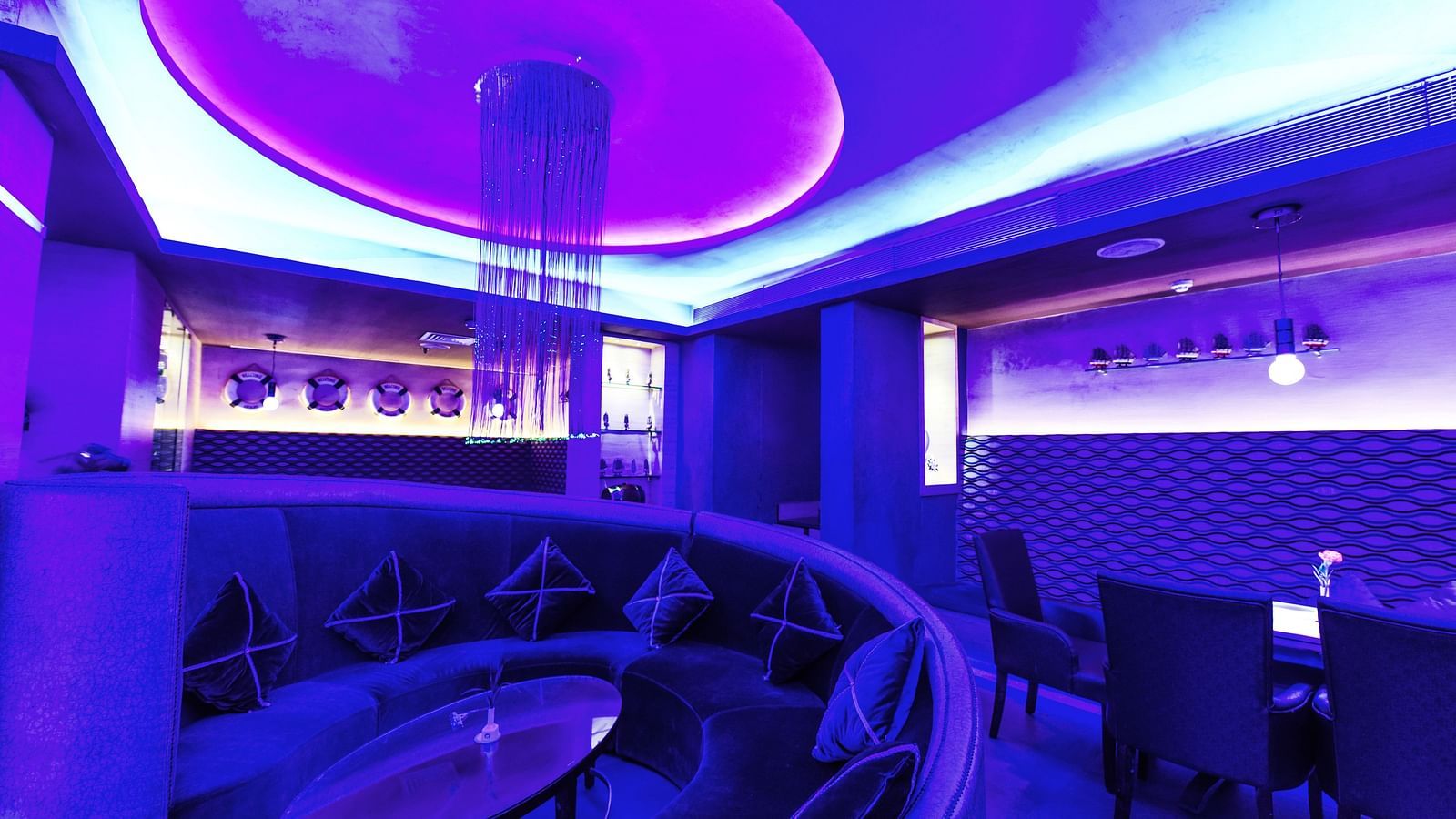 Image of Oceana bar with dim lighting and seating area at Swosti Grand, Bhubaneswar