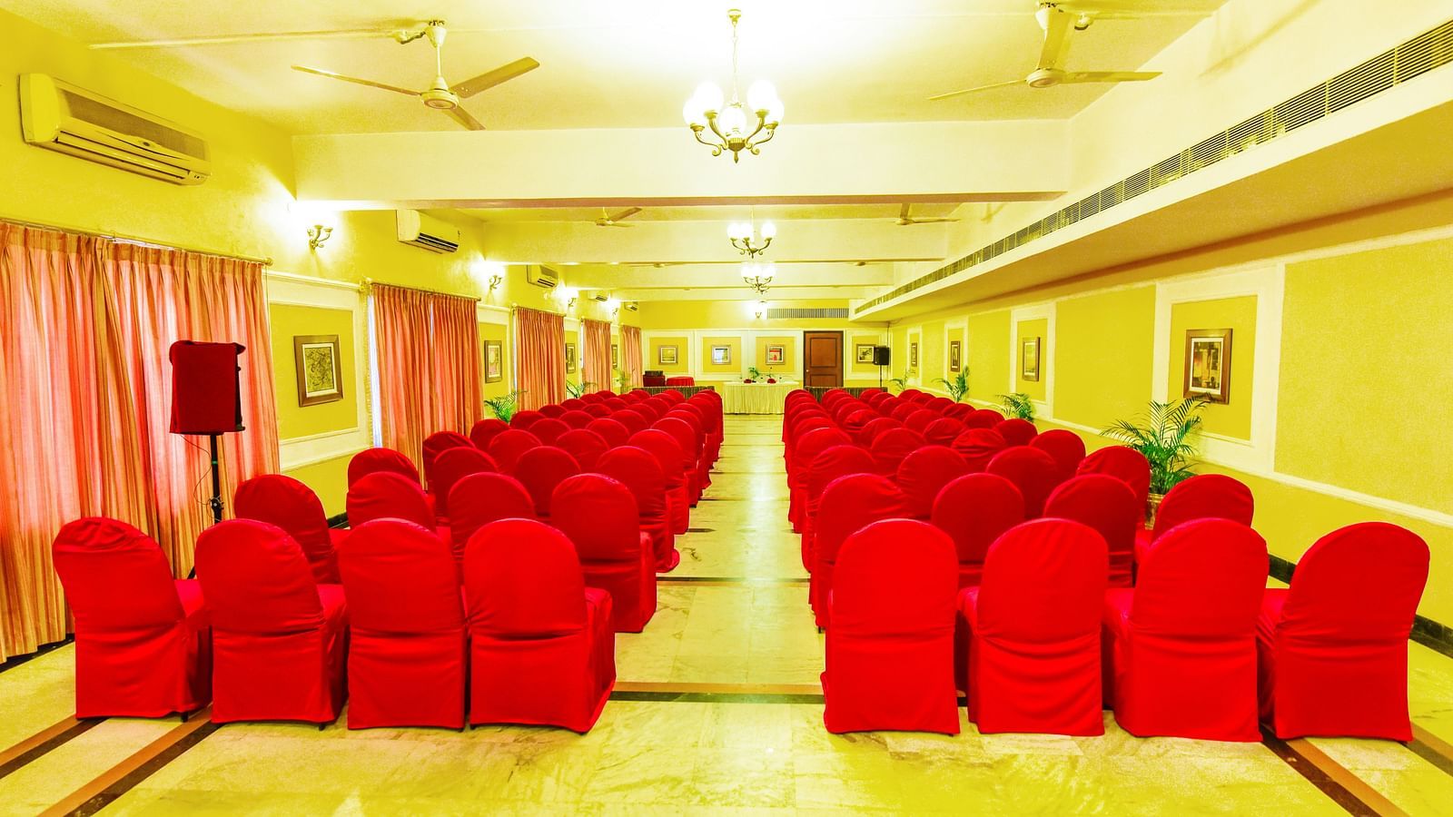 Banquet hall brightly lit and adorned with decorations throughout, perfectly set up for celebrations.