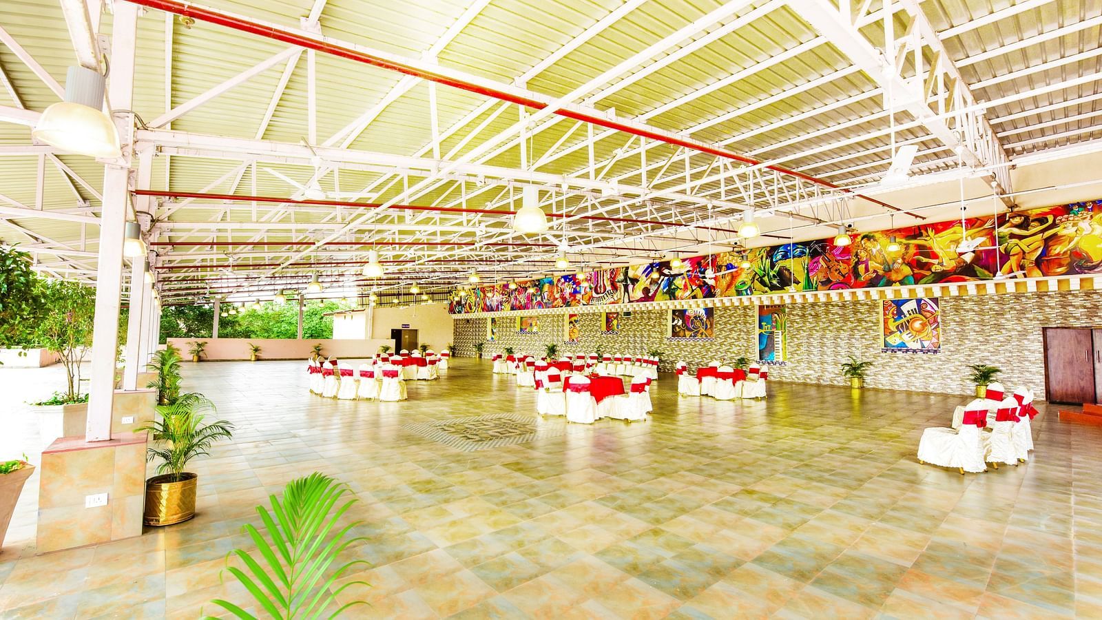 Celebration-ready banquet hall, featuring bright lighting and detailed decorations across the entire space.