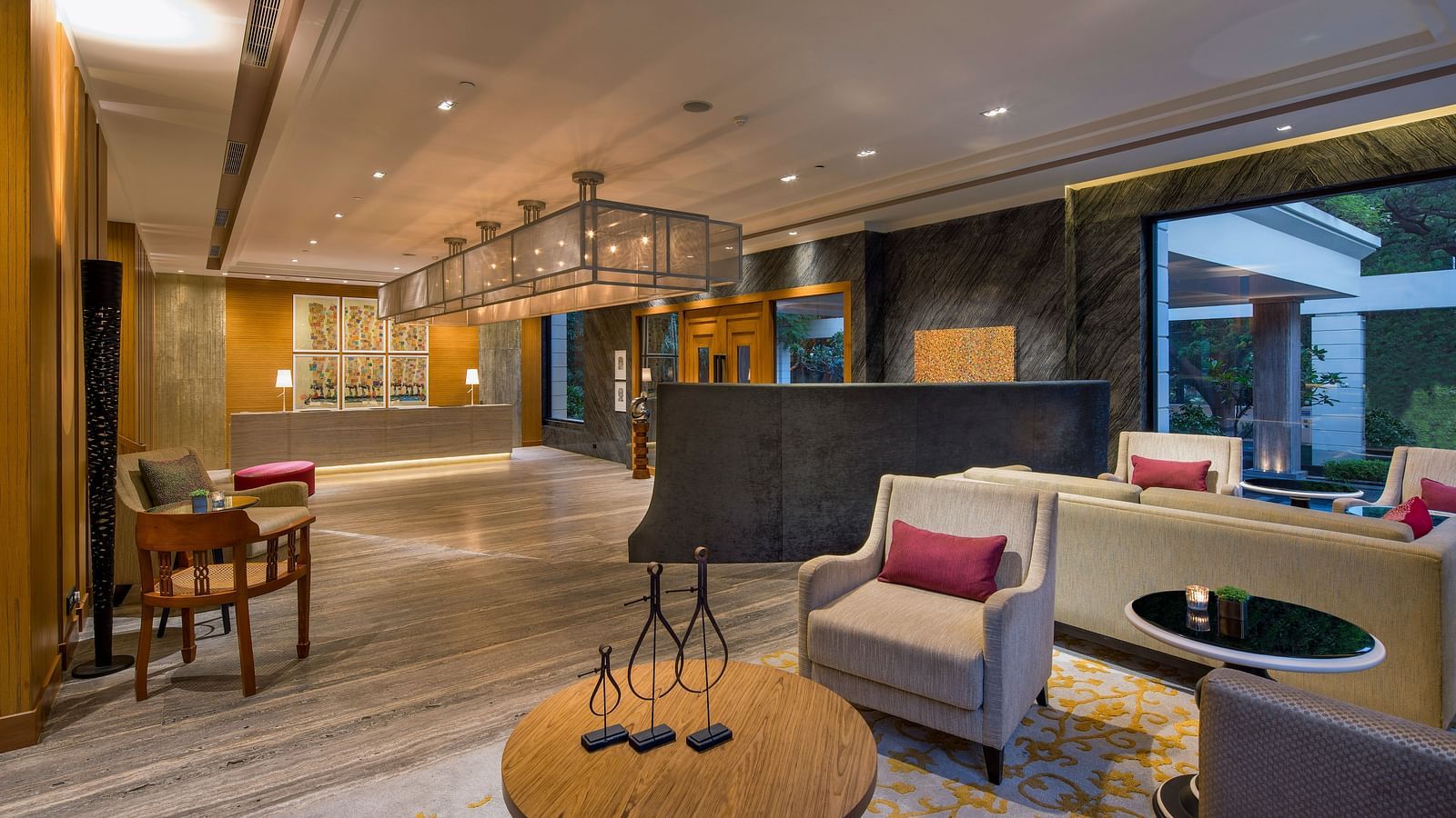 Image of a Lobby sitting area at The Raintree St. Mary s Road with high ceiling and chic decor.