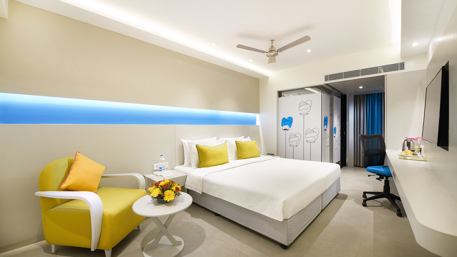side view of a bedroom with a wall painting at  Zibe Salem by GRT Hotels