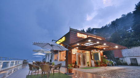 View of DLS Highland Resort and Spa, Mussoorie with comfortable seating area at the front. 