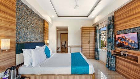 Stylish room at Mayur Retreat with elegant furnishings, blue-themed decor, and a serene ambiance.