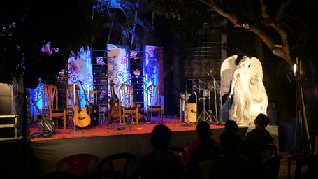 Event place at Rangamati Garden Resort featuring a stage, musical instruments, and a statue.